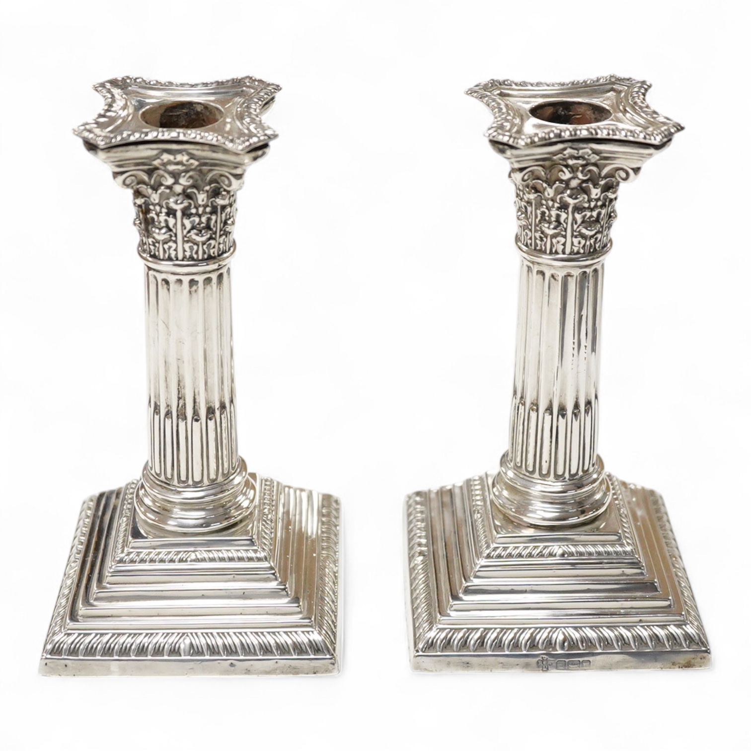 A pair of Edwardian silver mounted Corinthian column dwarf candlesticks, by Jay, Richard Attenborough Co Ltd, Sheffield, 1905, height 16.3cm, weighted.